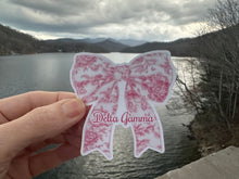 Load image into Gallery viewer, Sticker | DG_E | Delta Gamma Toile Bow | Waterproof Vinyl Sticker | White | Permanent | Removable | Window Cling | Glitter | Holographic
