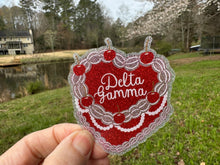 Load image into Gallery viewer, Sticker | DG_C | Delta Gamma Heart Shaped Cake | Waterproof Vinyl Sticker | White | Clear | Permanent | Removable | Window Cling | Glitter | Holographic